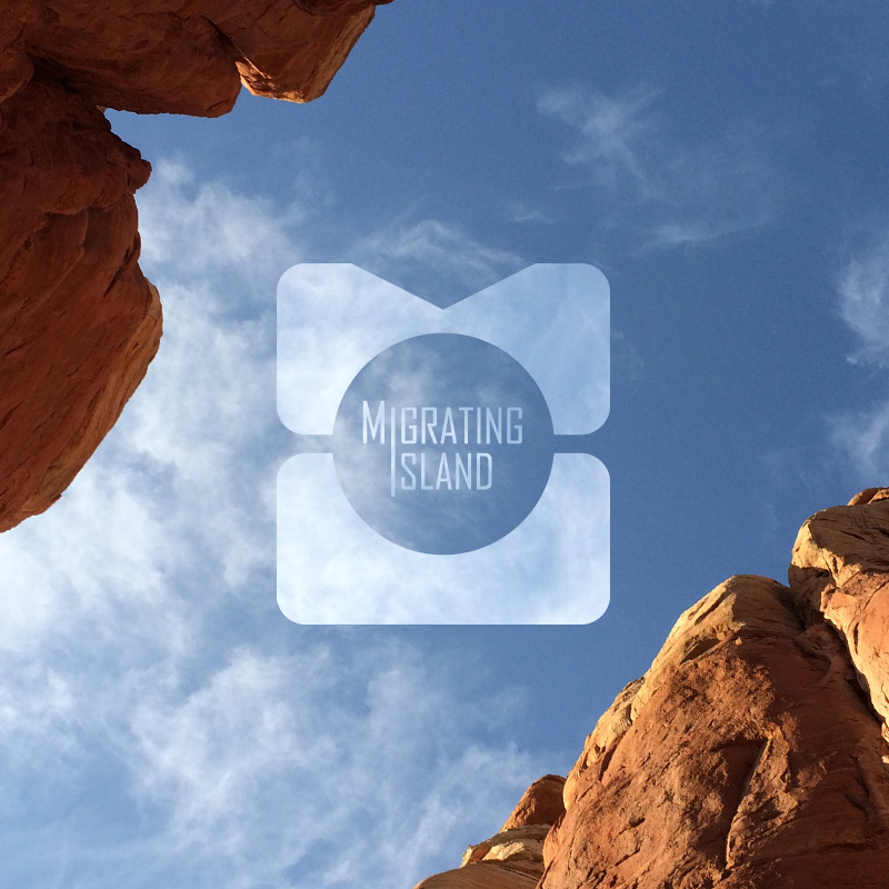 Migrating Island M.I. Logo with Cathedral Rock imagery inside its shape.
